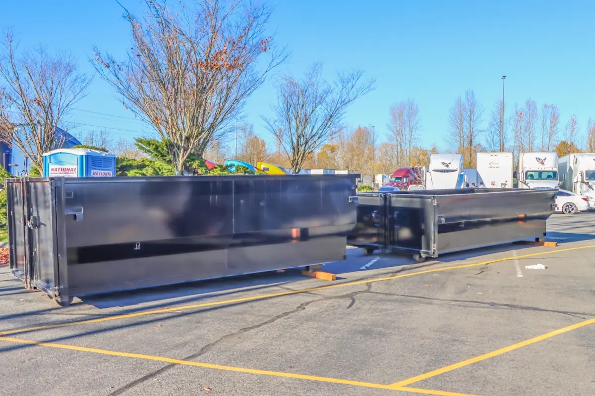 Professional dumpster rental service with roll-off container on residential driveway in Rancho Calaveras